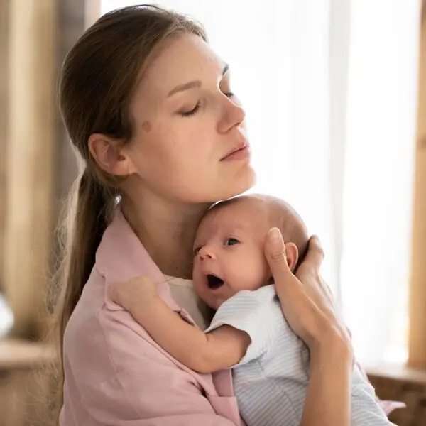 A woman holding a baby